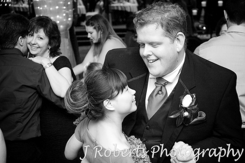 Groomsman dancing with partner at wedding reception - wedding photography sydney